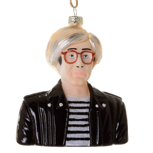 Decorative ornament shaped like Andy Warhol with white hair, glasses and a black leather jacket over a striped t shirt on a white background