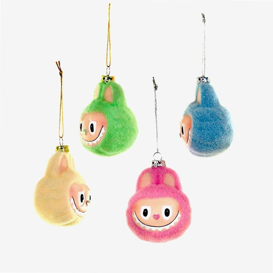 Set of colorful plush ornaments shaped like cartoon character monsters on a white background