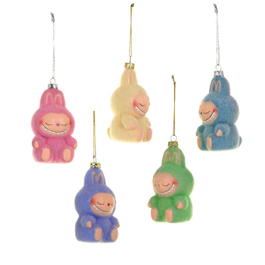 Set of colorful friendly monster-like ornaments with smiling faces on a white background