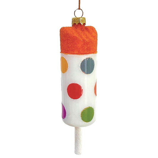 Decorative ornament resembling an orange sherbet pushup treat in a cylinder decorated with colorful polka dots with a sparkly stick at the bottom, on a white background