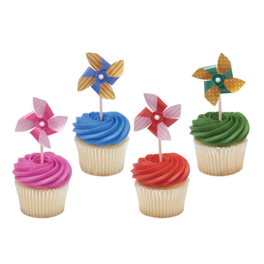 Four cupcakes with colorful frosting and windmill toppers on a white background