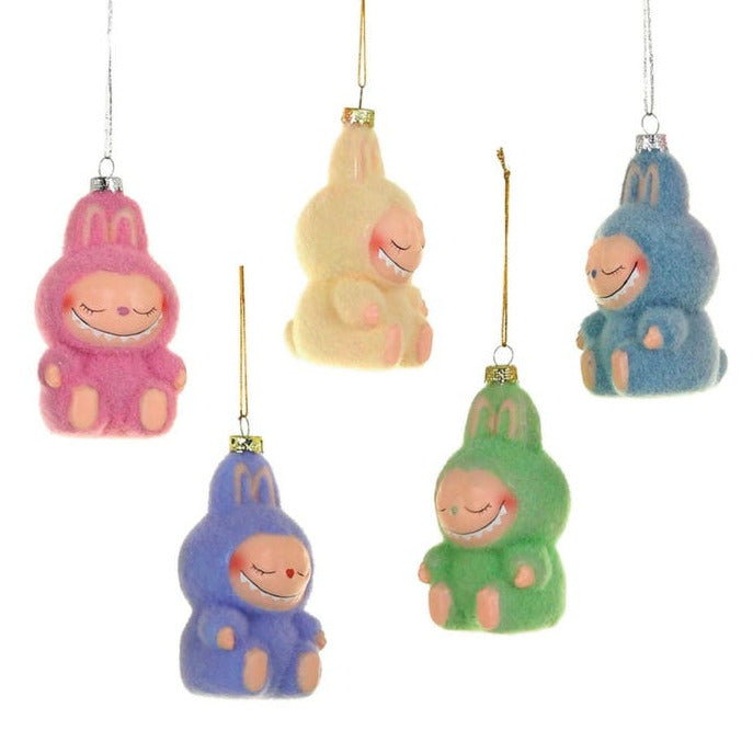 Set of colorful friendly monster-like ornaments with smiling faces on a white background