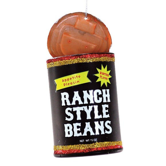 Decorative glass ornament shaped like a can of beans with top that looks like it has been partially opened with a can opener. Glitter bands around the can and the words RANCH STYLE BEANS in cowboy font.